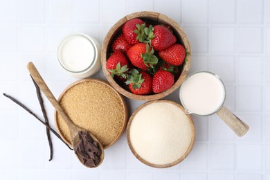 Photo of Different ingredients for panna cotta. Milk, sugar, vanilla, chocolate and strawberries on white tiled table, flat lay