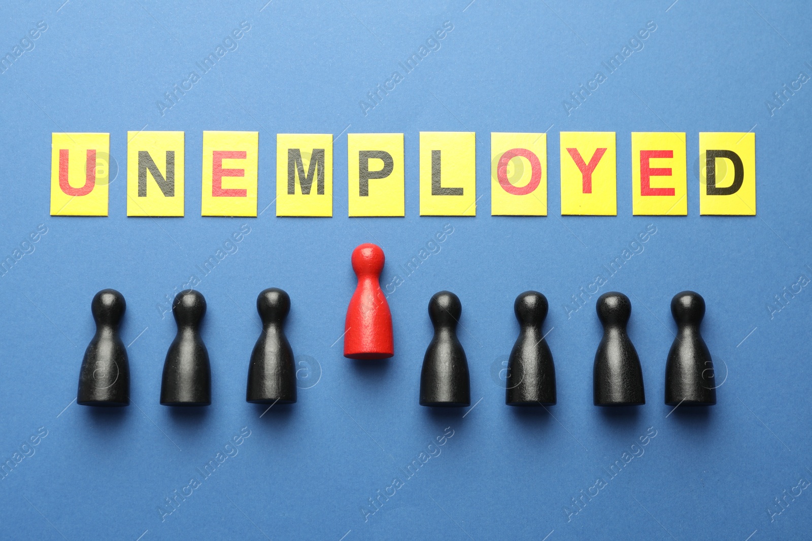 Word Unemployed and human figures on blue background, flat lay Photo of Word Unemployed and human figures on blue background, flat lay