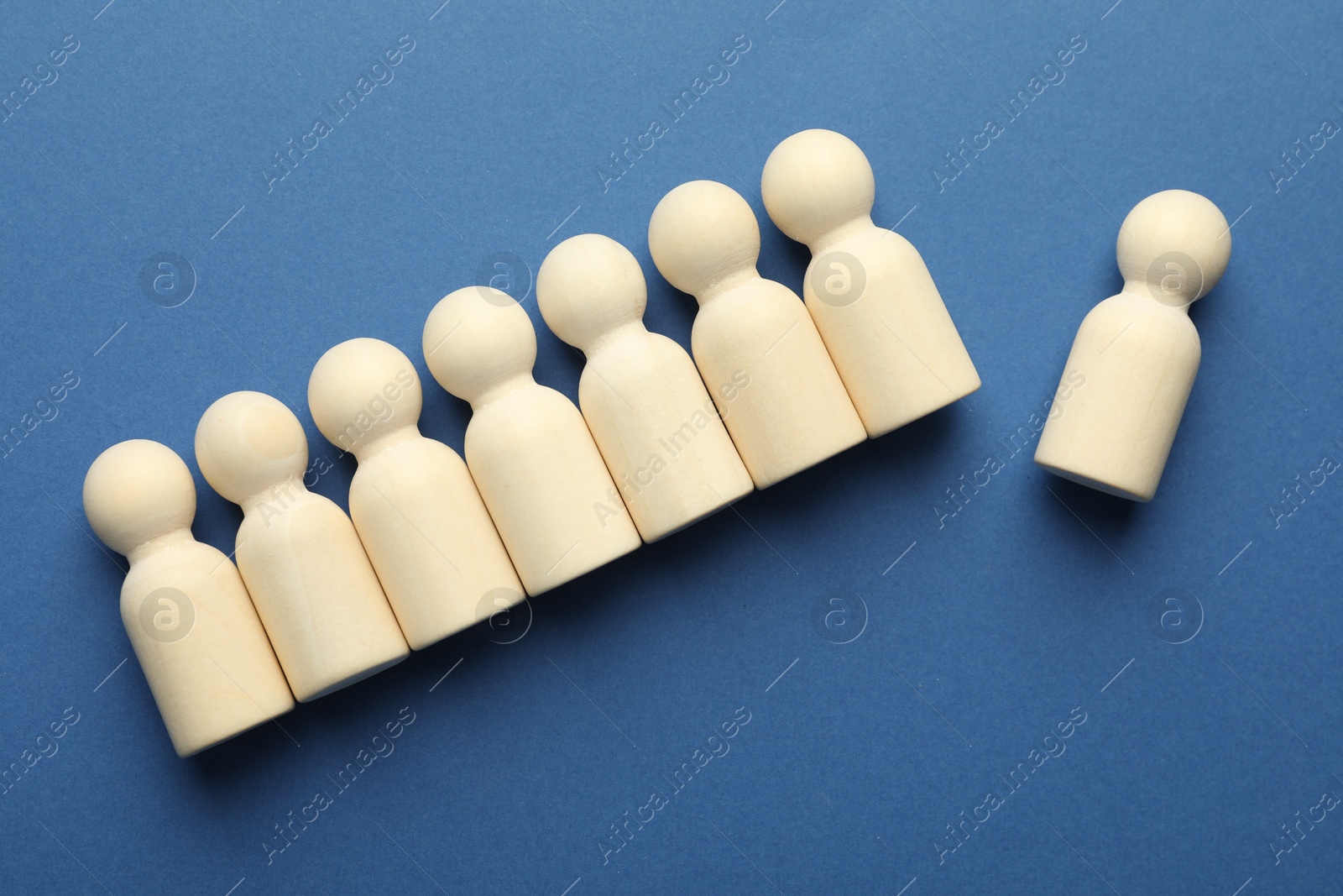 Photo of Unemployment. Human figures on blue background, flat lay