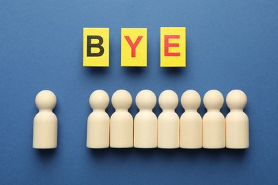 Photo of Dismissal. Word Bye and human figures on blue background, flat lay