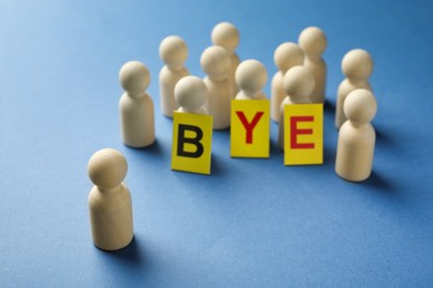 Photo of Dismissal. Word Bye and human figures on blue background