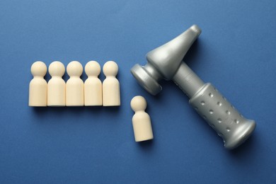 Photo of Unemployment. Human figures and hammer on blue background, flat lay
