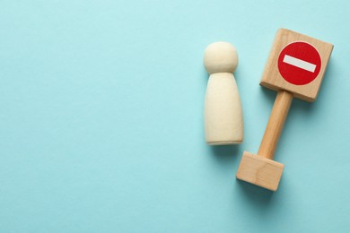 Photo of Unemployment. Human figure and stop sign on light blue background, top view. Space for text
