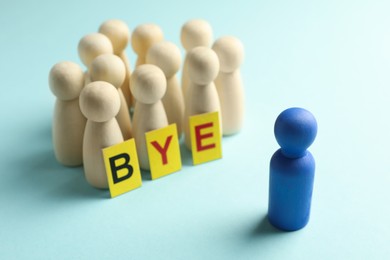 Photo of Dismissal. Word Bye and human figures on light blue background