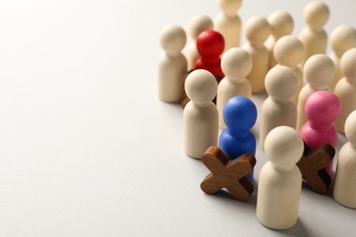 Photo of Unemployment. Many different human figures on light background, closeup. Space for text