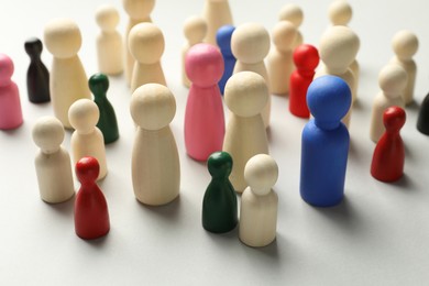 Photo of Unemployment. Many different human figures on light background, closeup