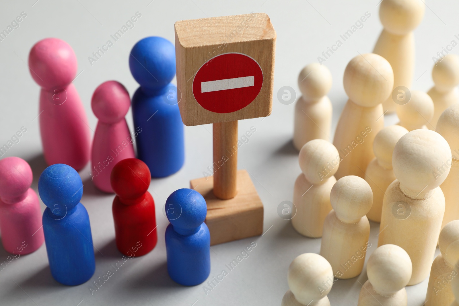 Unemployment. Many different human figures and stop sign on light background, closeup Photo of Unemployment. Many different human figures and stop sign on light background, closeup