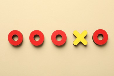 Photo of Unemployment. Tic tac toe figures on beige background, flat lay