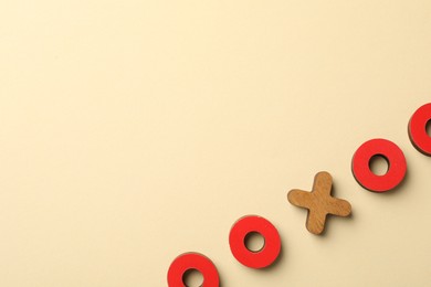 Photo of Unemployment. Tic tac toe figures on beige background, flat lay. Space for text
