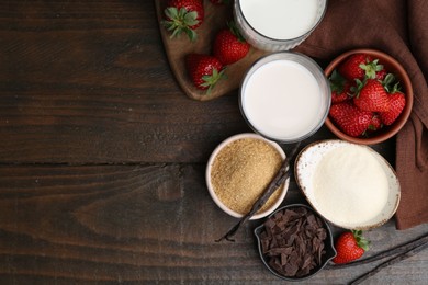 Photo of Different ingredients for panna cotta. Milk, sugar, vanilla, chocolate and strawberries on wooden table, flat lay. Space for text