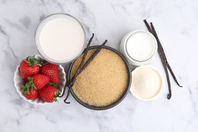 Photo of Different ingredients for panna cotta. Milk, sugar, vanilla and strawberries on white marble table, flat lay