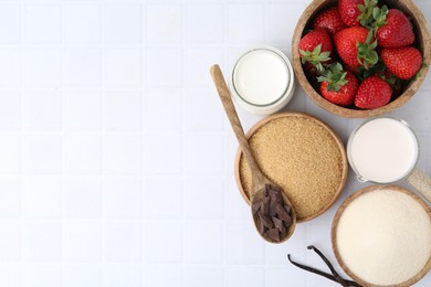 Photo of Different ingredients for panna cotta. Milk, sugar, vanilla, chocolate and strawberries on white tiled table, flat lay. Space for text