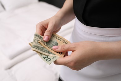 Photo of Chambermaid with tips indoors, closeup. Gratuity for work