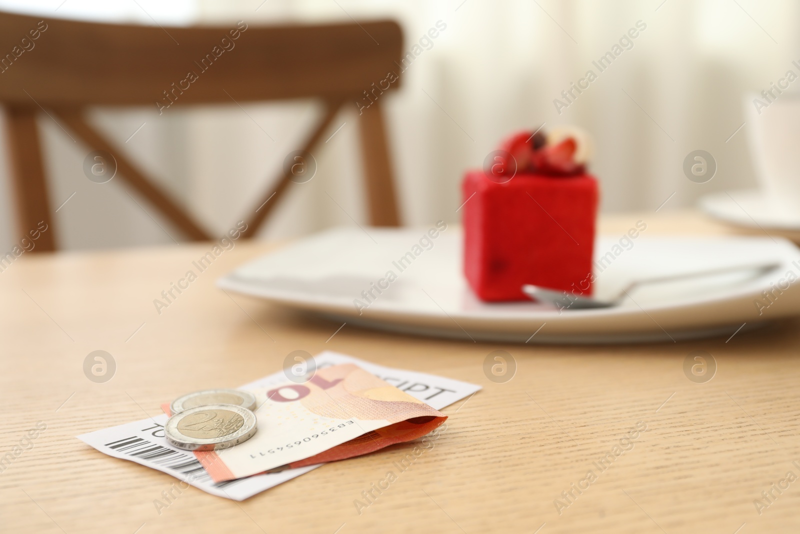 Tips and receipt on wooden table in restaurant, closeup. Gratuity for work Photo of Tips and receipt on wooden table in restaurant, closeup. Gratuity for work