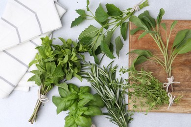 Photo of Different fresh green herbs on light table, flat lay
