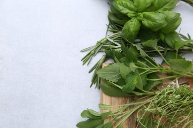 Photo of Different fresh green herbs on light table, flat lay. Space for text