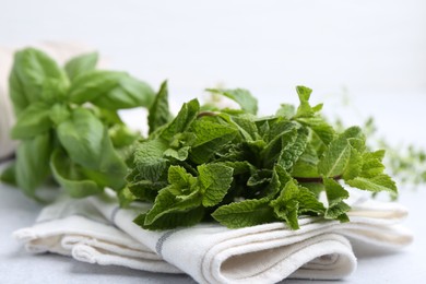 Photo of Different fresh green herbs on light table, closeup