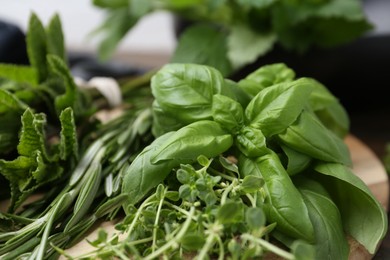Photo of Different fresh green herbs on table, closeup