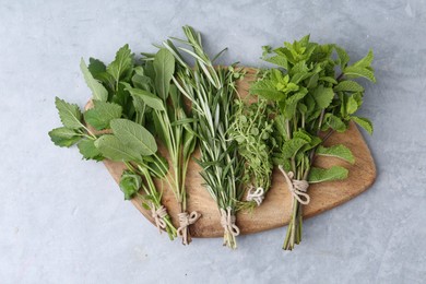 Photo of Different fresh green herbs on grey table, top view