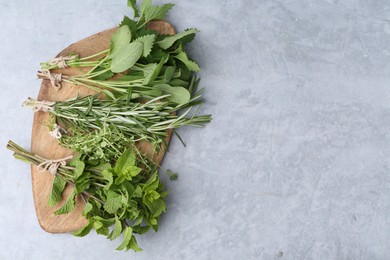 Photo of Different fresh green herbs on grey table, top view. Space for text