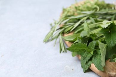 Photo of Different fresh green herbs on grey table, closeup. Space for text