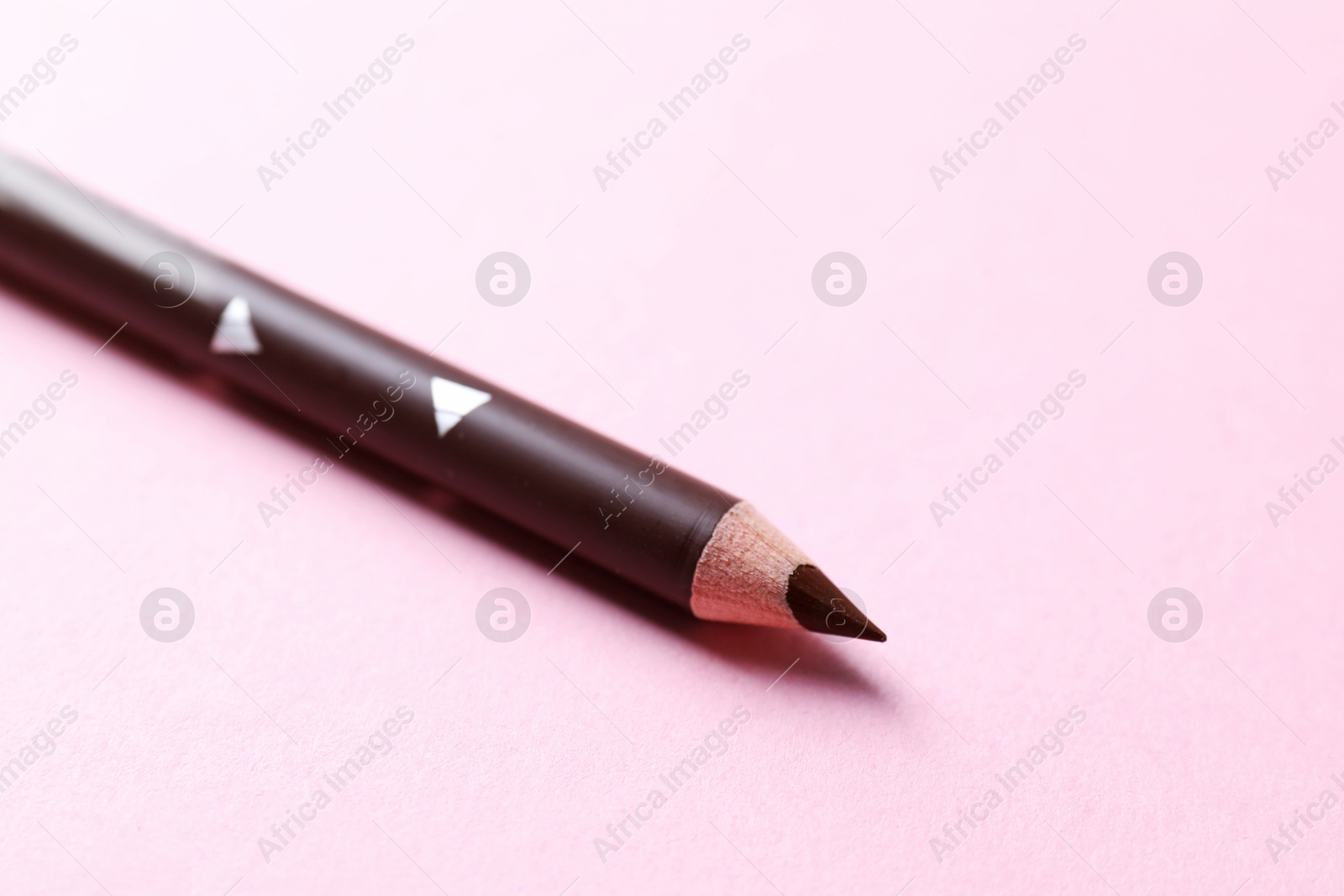One eyebrow pencil on pink background, closeup. Space for text Photo of One eyebrow pencil on pink background, closeup. Space for text