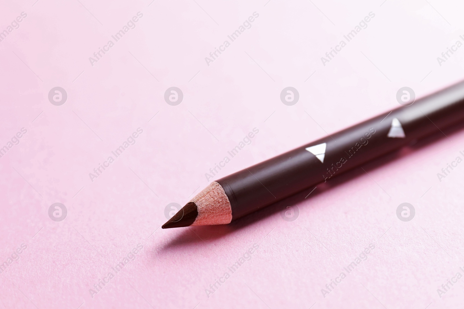 One eyebrow pencil on pink background, closeup. Space for text Photo of One eyebrow pencil on pink background, closeup. Space for text