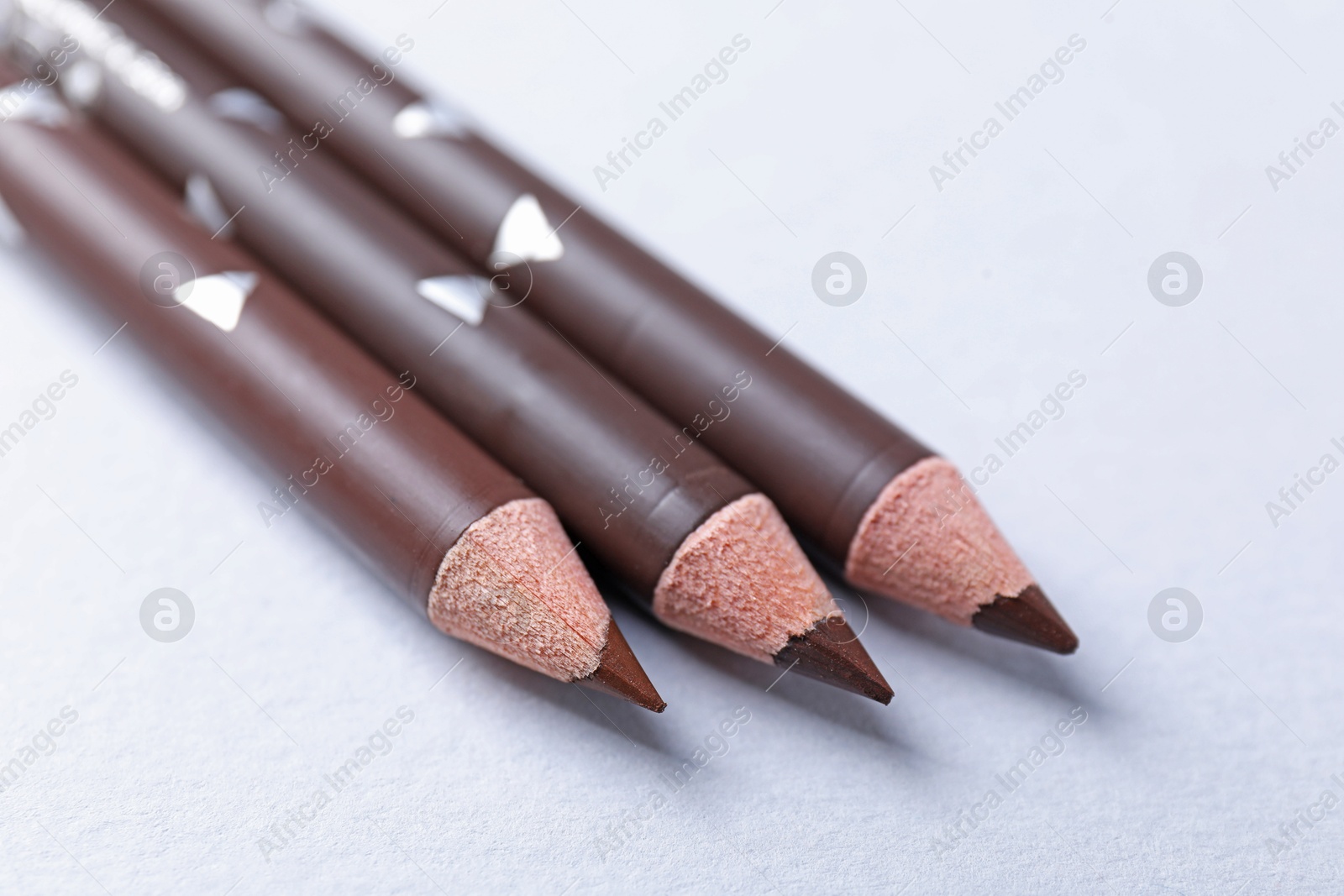 Three eyebrow pencils on white background, closeup Photo of Three eyebrow pencils on white background, closeup