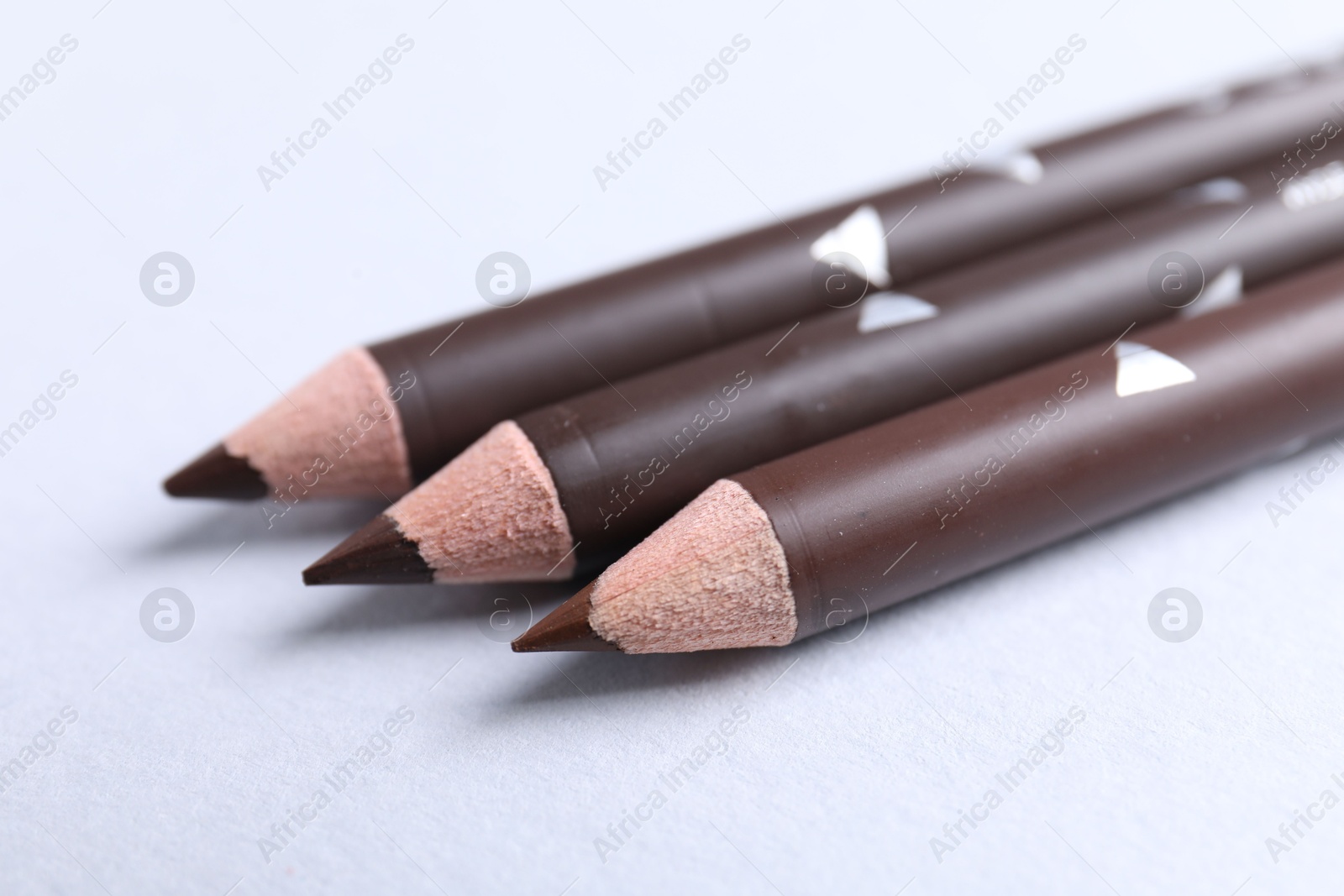 Three eyebrow pencils on white background, closeup Photo of Three eyebrow pencils on white background, closeup
