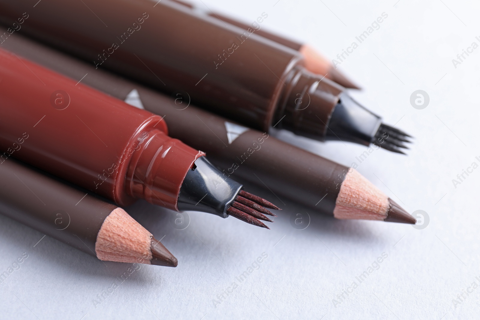 Different eyebrow pencils on white background, closeup Photo of Different eyebrow pencils on white background, closeup