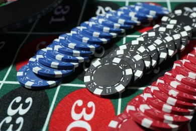 Photo of Casino chips on roulette table, closeup view