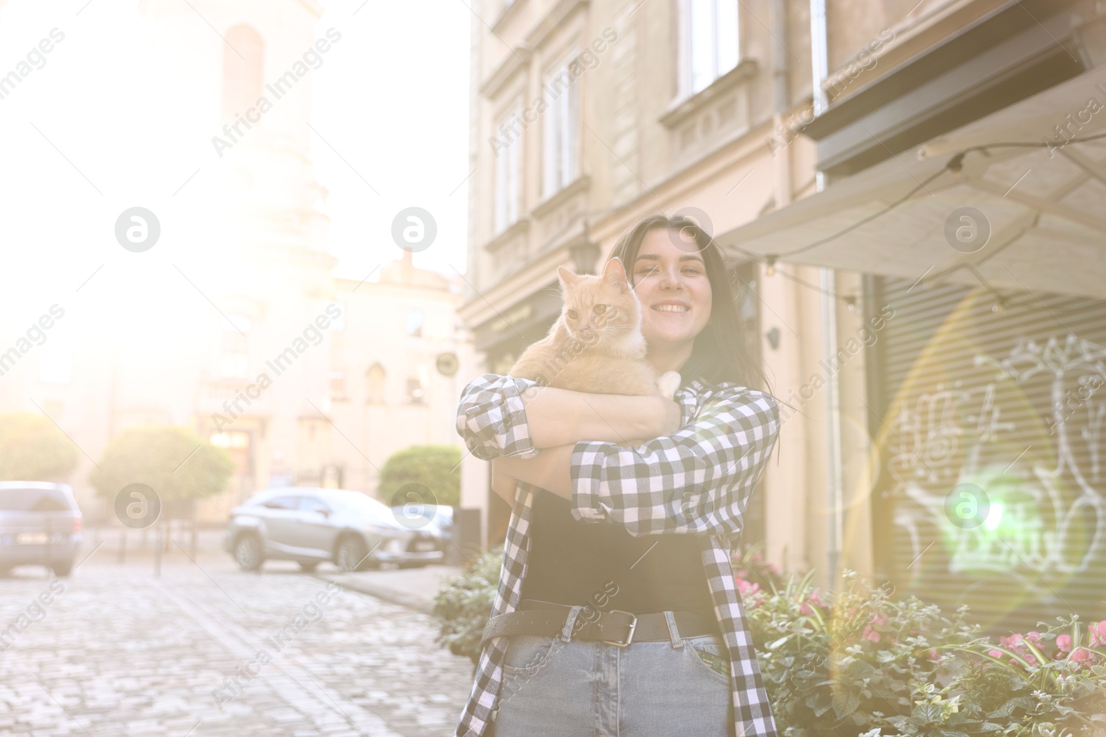 Woman with her cute cat outdoors on sunny day Photo of Woman with her cute cat outdoors on sunny day