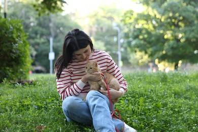Photo of Woman with her cute cat in park