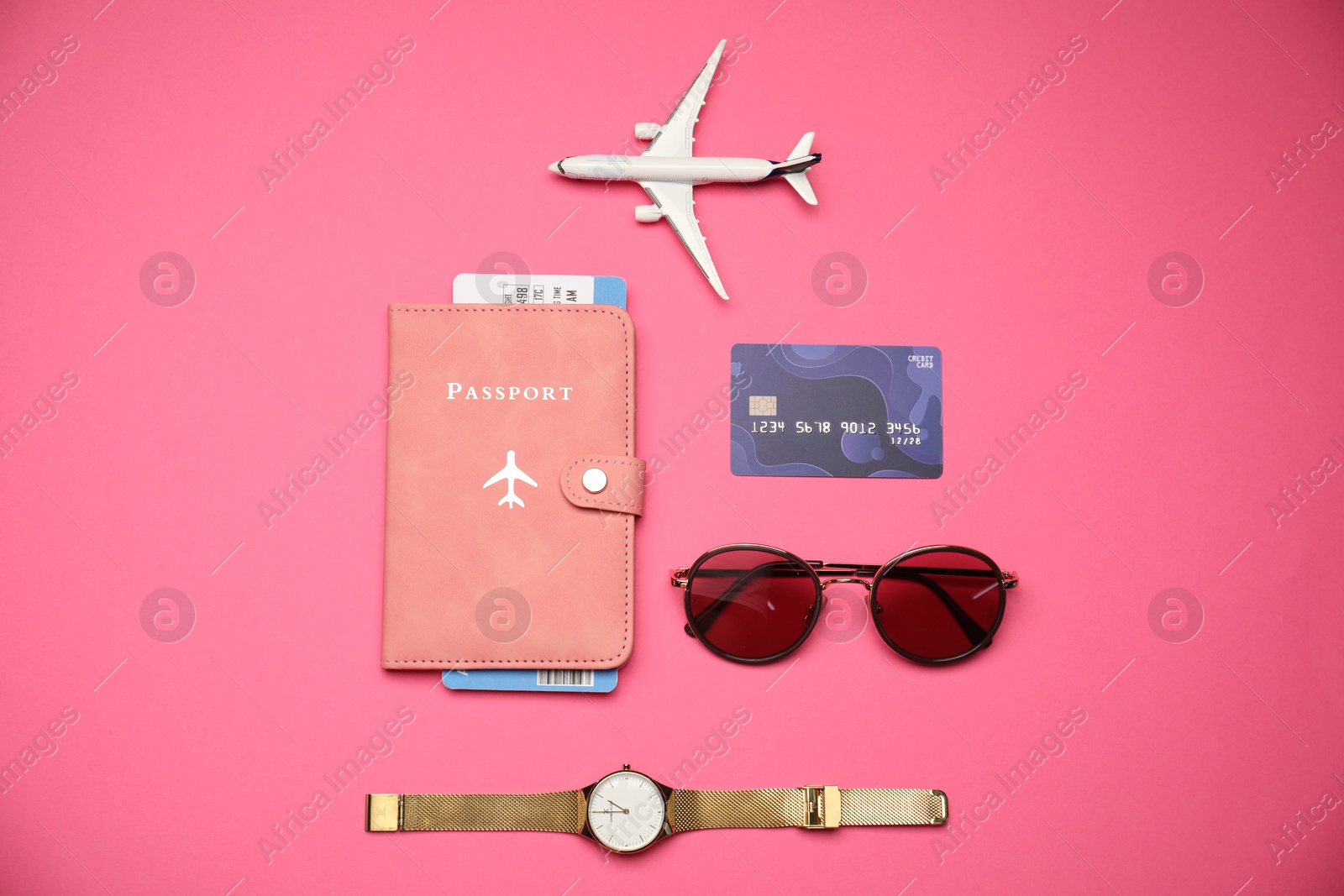 Airplane model, passport, flight ticket, credit card, and accessories on pink background, flat lay Photo of Airplane model, passport, flight ticket, credit card, and accessories on pink background, flat lay