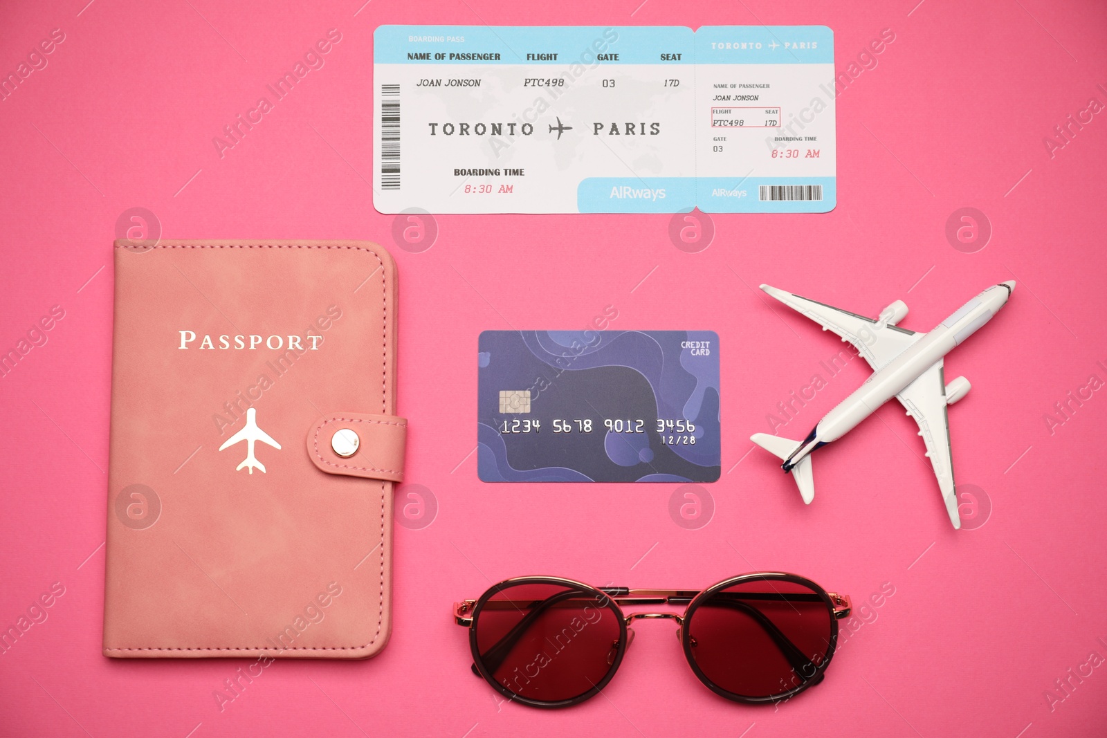 Airplane model, passport, flight ticket, credit card and sunglasses on pink background, flat lay Photo of Airplane model, passport, flight ticket, credit card and sunglasses on pink background, flat lay