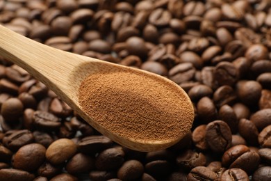 Photo of Spoon with instant coffee powder and beans, closeup