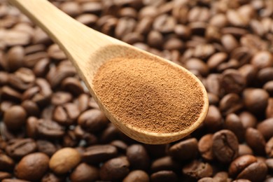 Photo of Spoon with instant coffee powder and beans, closeup