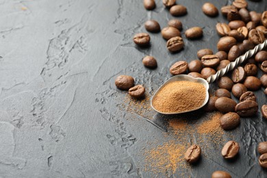 Photo of Spoon with instant coffee powder and beans on dark textured table, closeup. Space for text