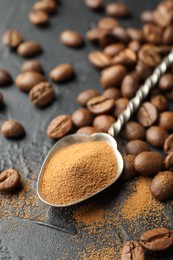 Photo of Spoon with instant coffee powder and beans on dark textured table, closeup