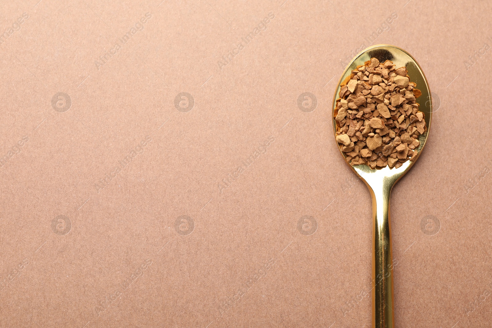 Spoon with granulated instant coffee on beige background, top view. Space for text Photo of Spoon with granulated instant coffee on beige background, top view. Space for text