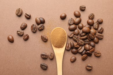Photo of Spoon with instant coffee powder and beans on beige background, flat lay