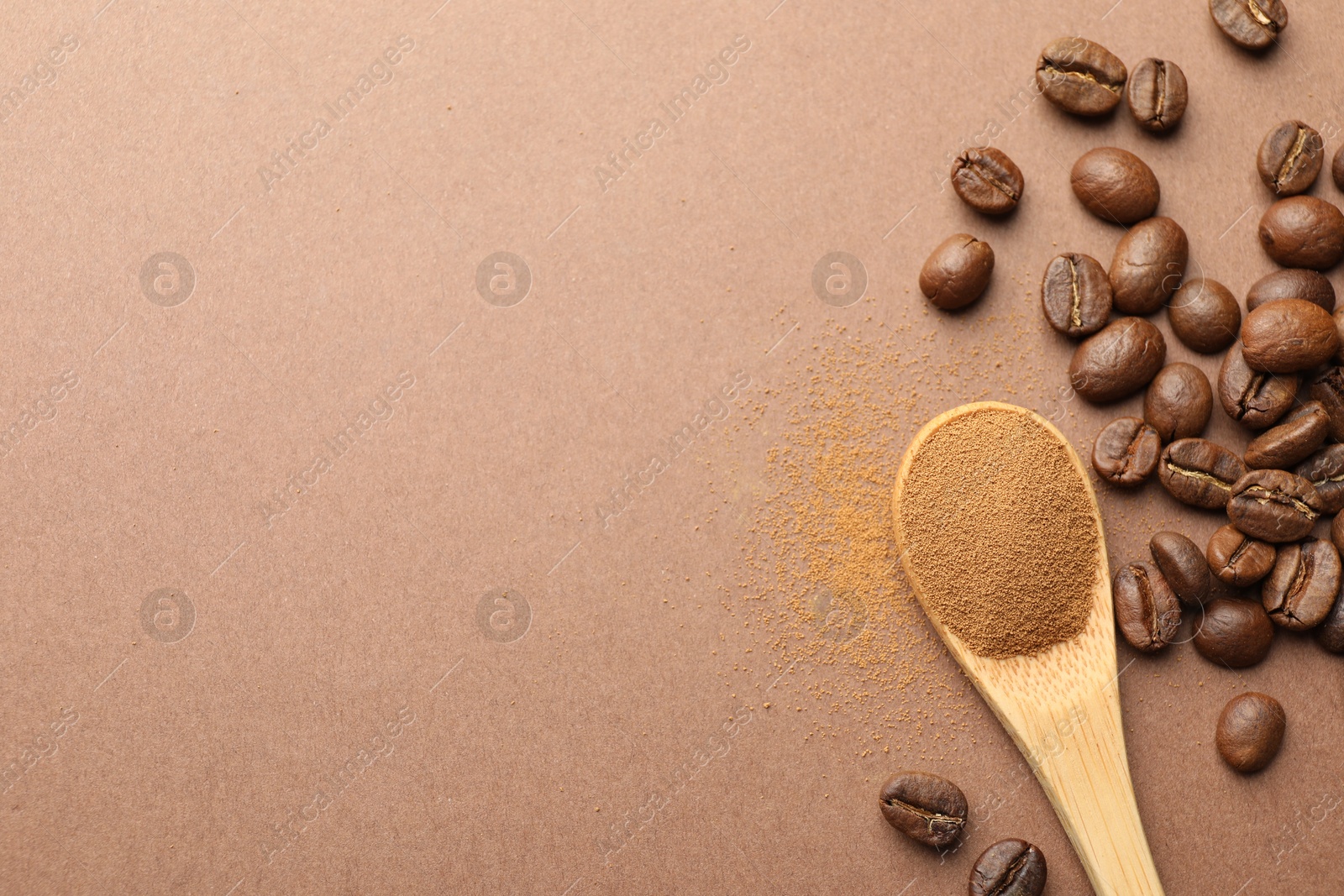 Spoon with instant coffee powder and beans on beige background, flat lay. Space for text Photo of Spoon with instant coffee powder and beans on beige background, flat lay. Space for text