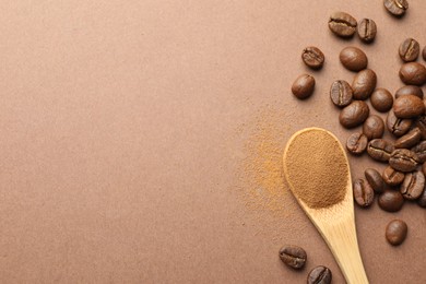 Photo of Spoon with instant coffee powder and beans on beige background, flat lay. Space for text