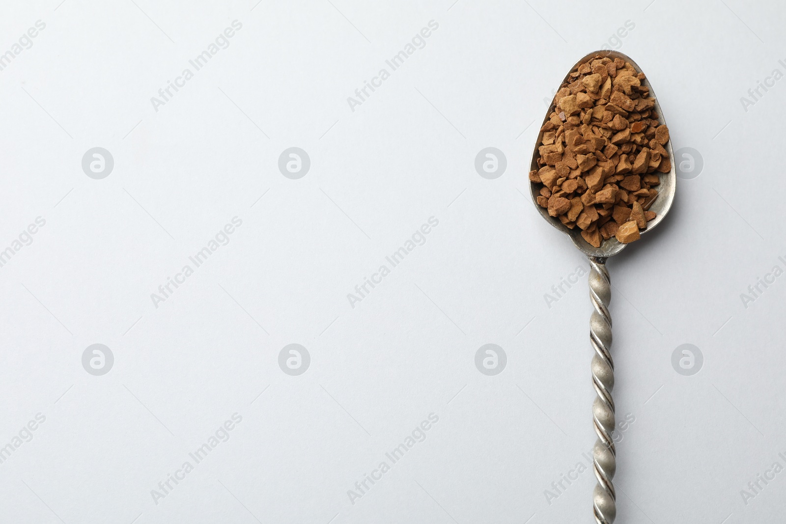 Spoon with granulated instant coffee on white background, top view. Space for text Photo of Spoon with granulated instant coffee on white background, top view. Space for text