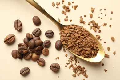 Photo of Spoon with granulated instant coffee and beans on beige background, flat lay