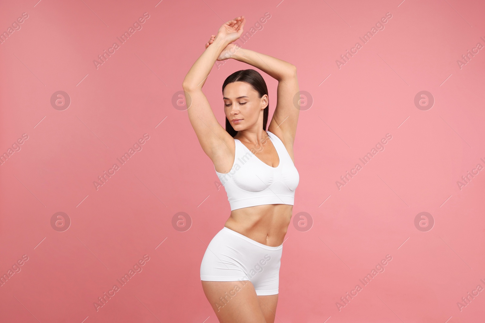 Photo of Fit woman with perfect body on pink background