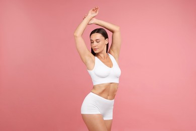 Photo of Fit woman with perfect body on pink background
