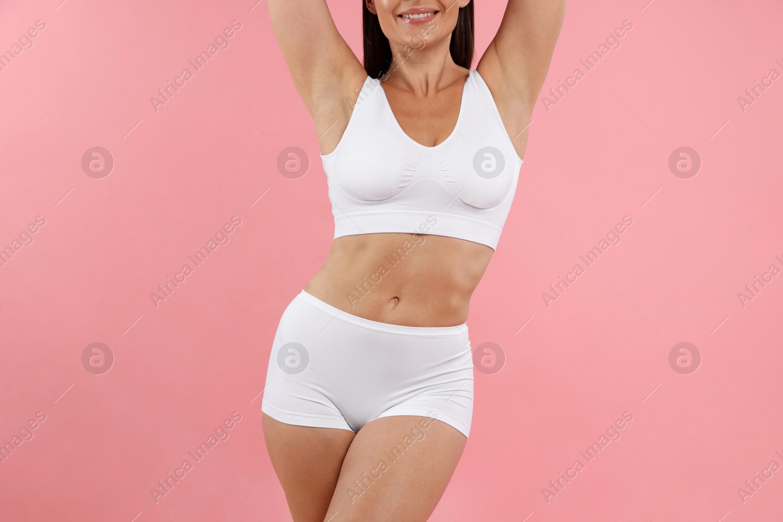 Fit woman with perfect body on pink background, closeup Photo of Fit woman with perfect body on pink background, closeup