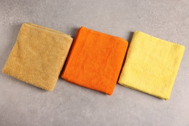 Photo of Colorful towels on grey table, flat lay