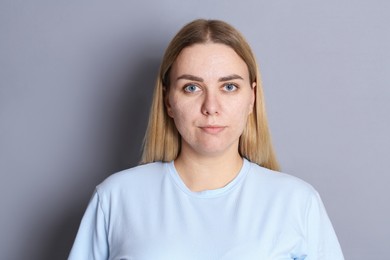 Photo of Portrait of beautiful woman on grey background